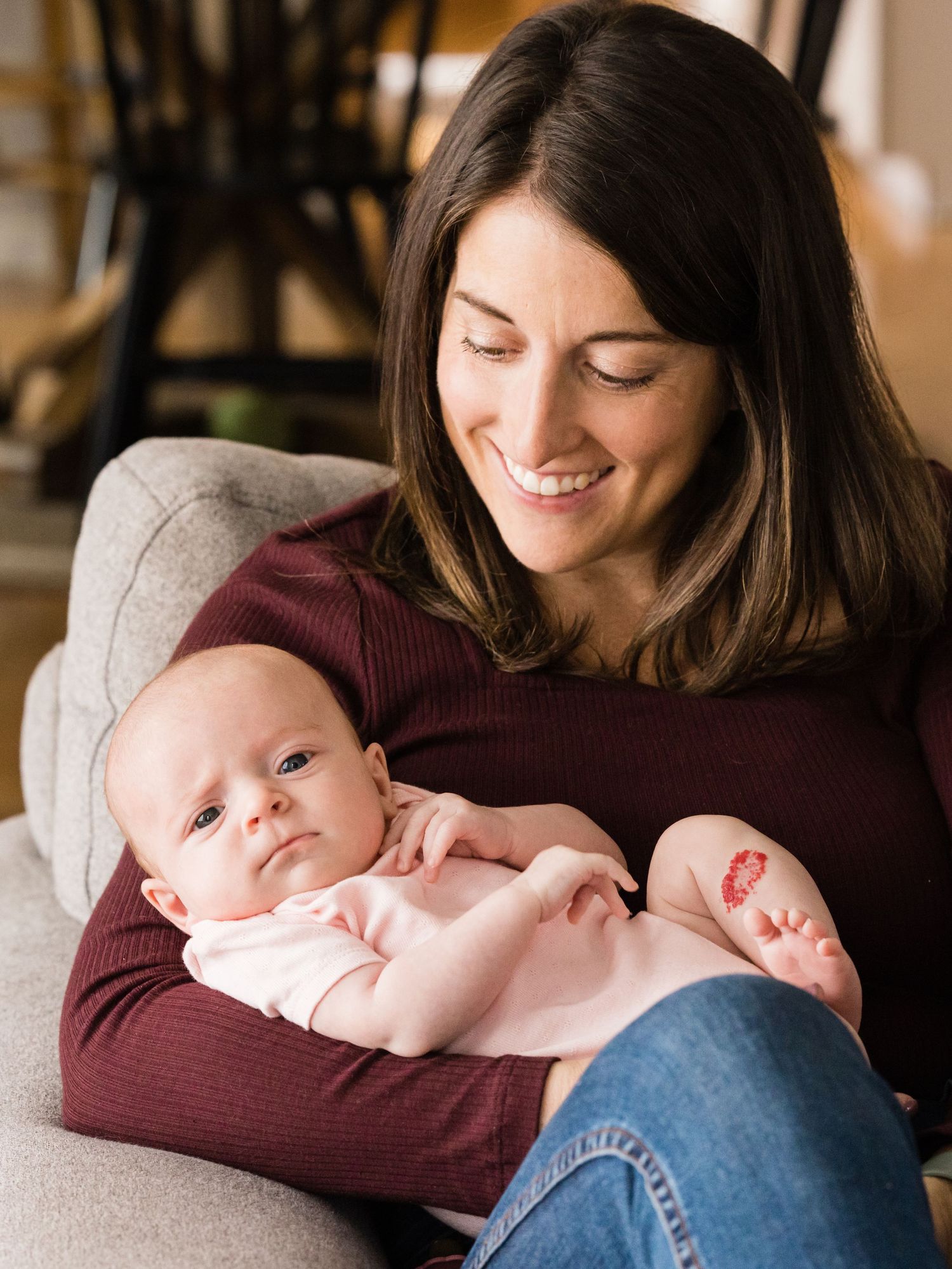 mother holding baby girl who has confused expression