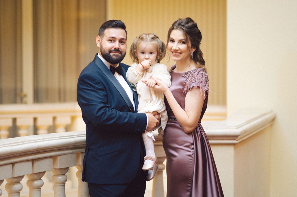 A happy family moment captured at a formal event in an elegant venue.