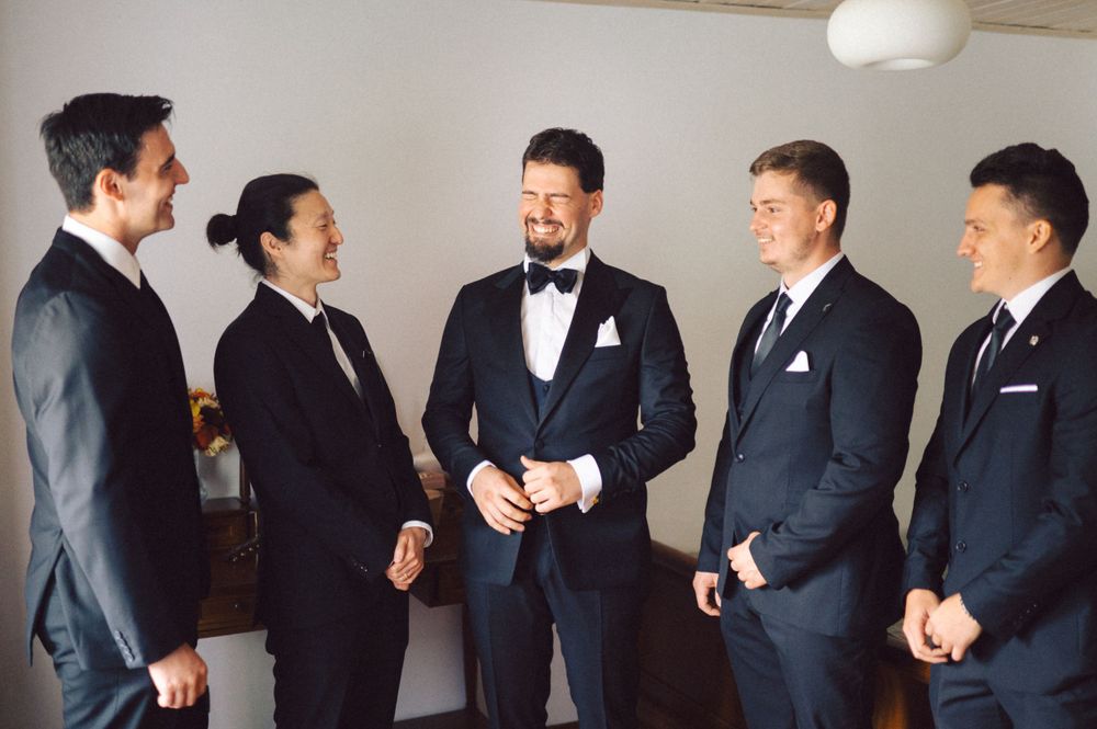 Group wearing formal suits and bow ties gathered before an event.