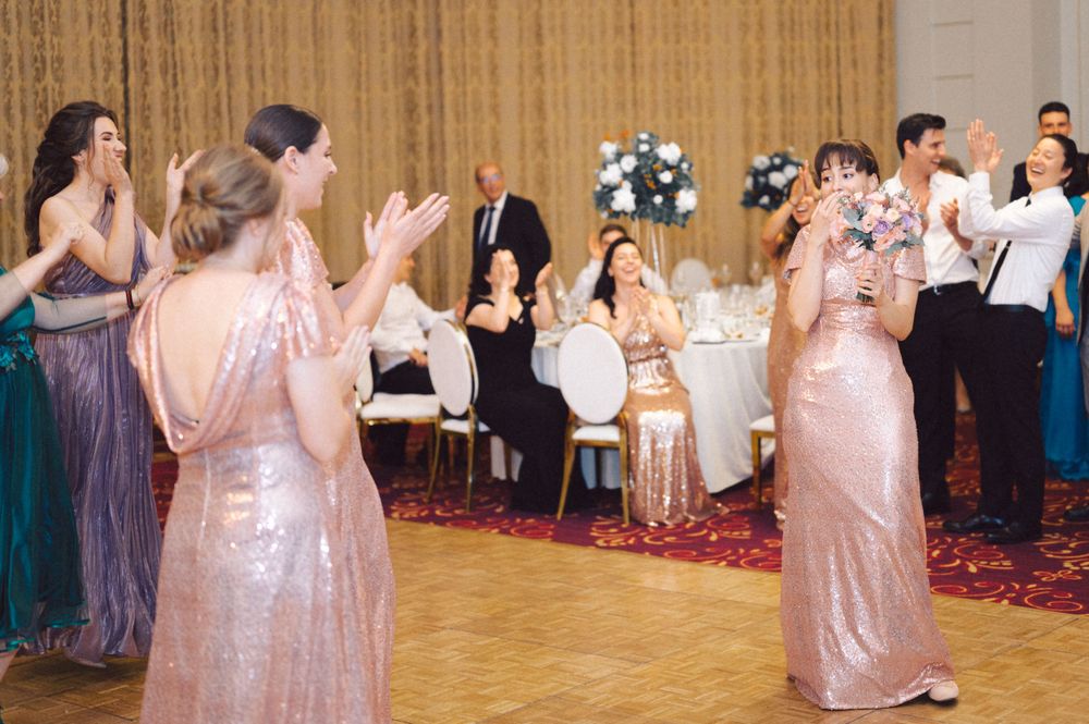 Wedding reception dance floor filled with guests in elegant evening attire.