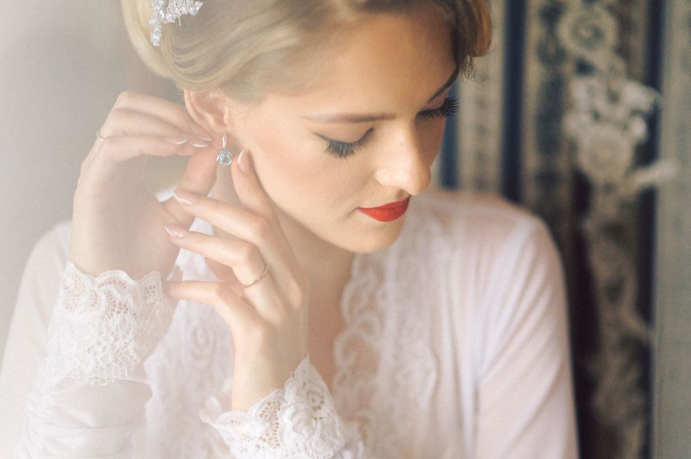 Soft focus portrait showing classic bridal styling with elegant makeup and accessories.
