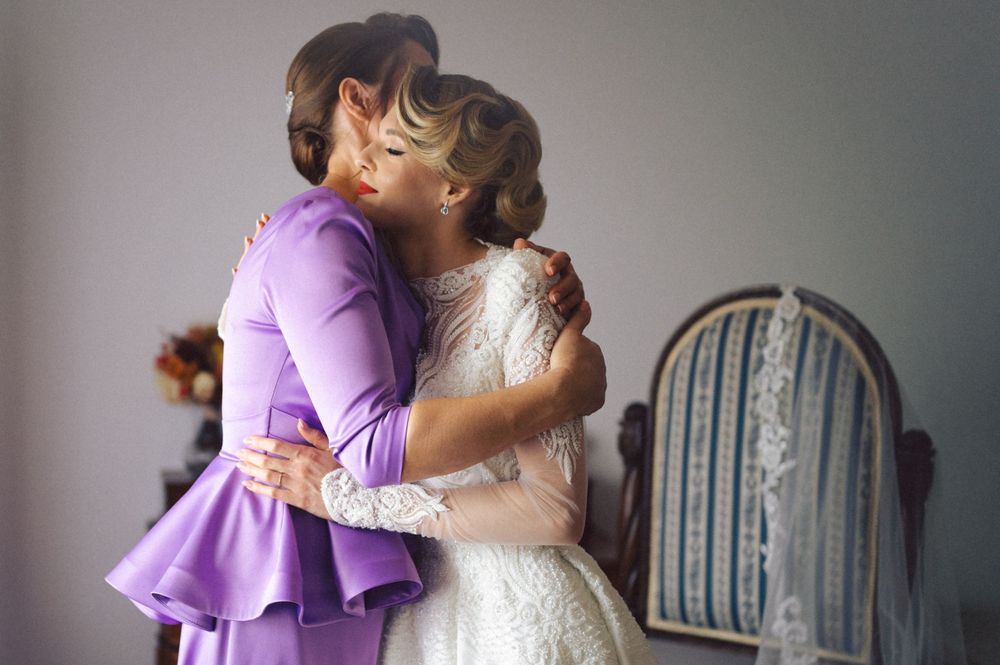 Emotional moment between two people sharing an embrace during wedding preparations.
