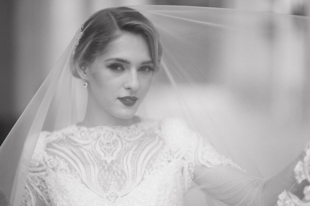 A black and white bridal portrait showcasing delicate lace details and a classic veil.