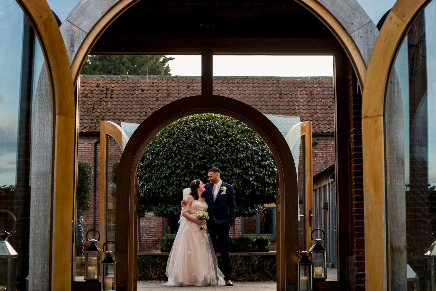 Wedding venue interior with beautiful wooden arched windows and natural lighting.