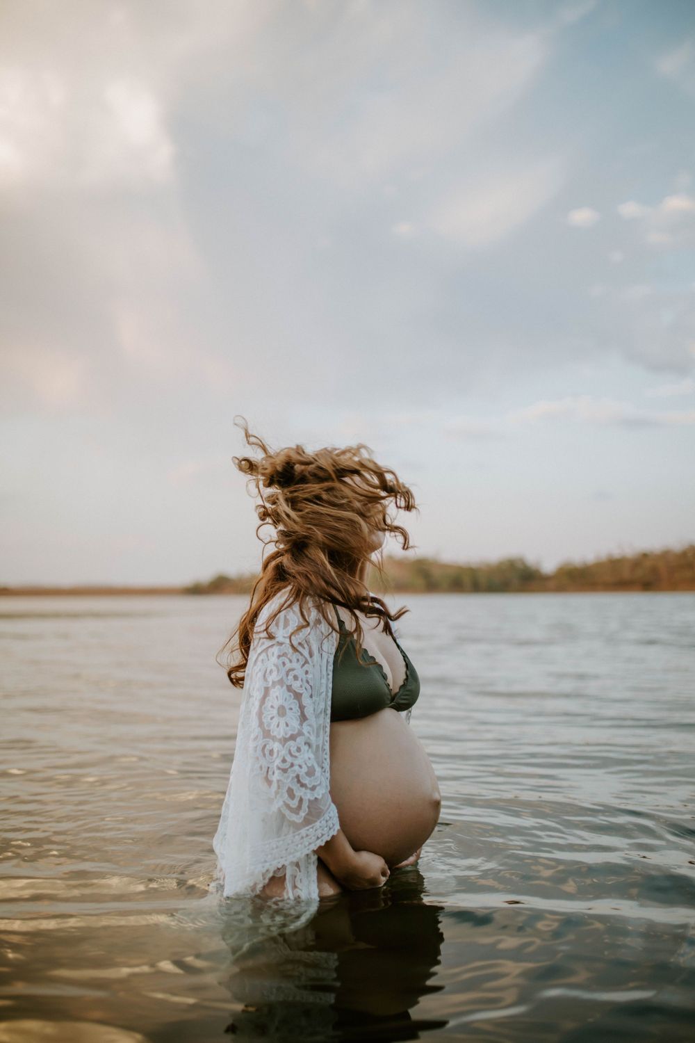 Mama to be whipping her while standing in water at Lake Moondarra, Mount Isa