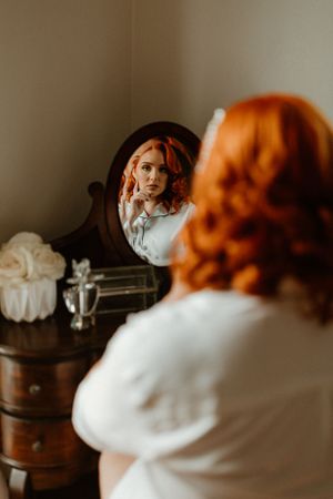Reflection in vintage mirror shows preparation for a special occasion.