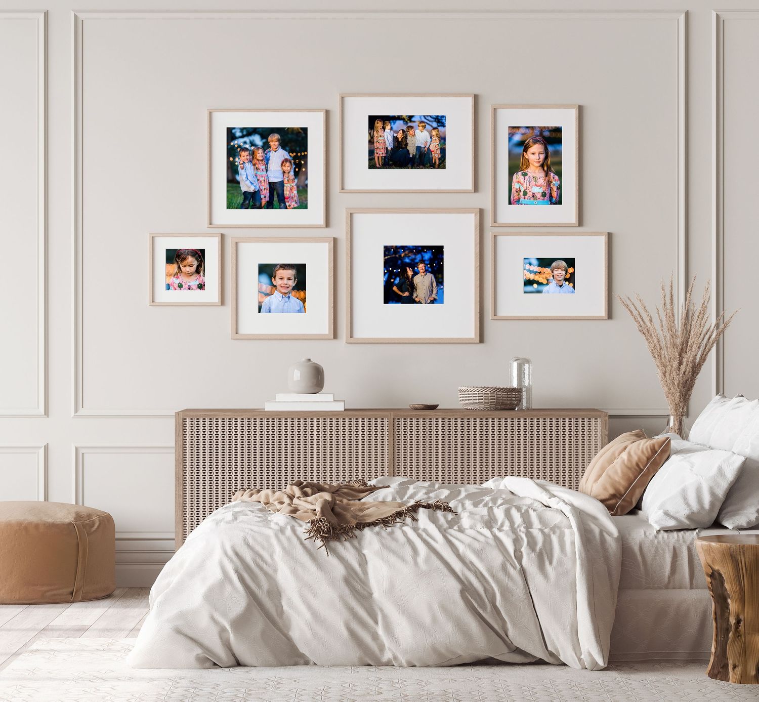 Clean white bedroom with gallery wall of framed photos above modern upholstered headboard.