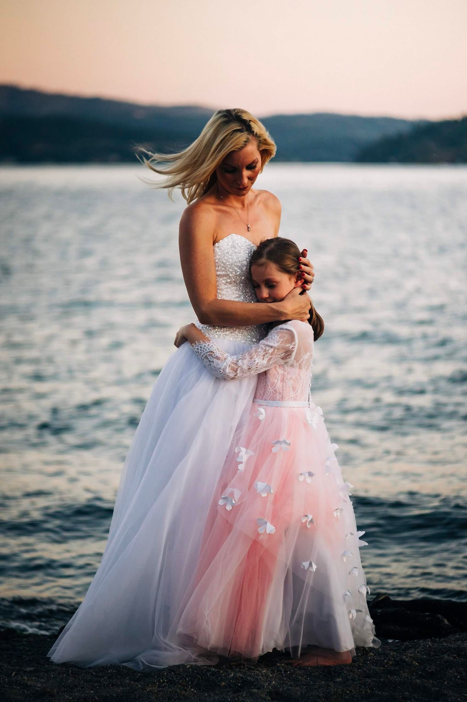 Stunning bride embracing her daughter in CDA Idaho
