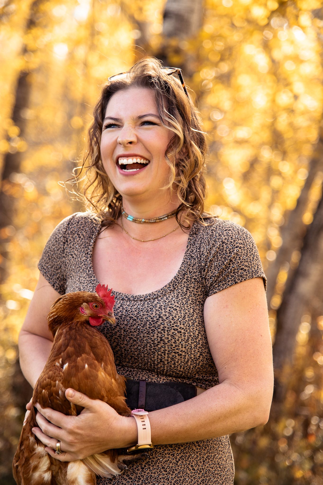 Farmer woman holding a chicken, smiling, Steinbach manitova