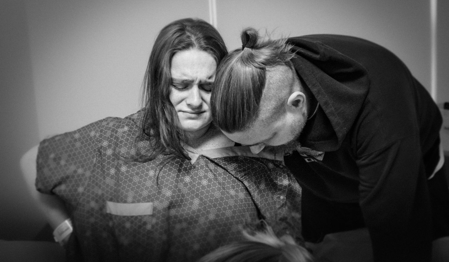 Compassionate care being provided in a black and white hospital setting.