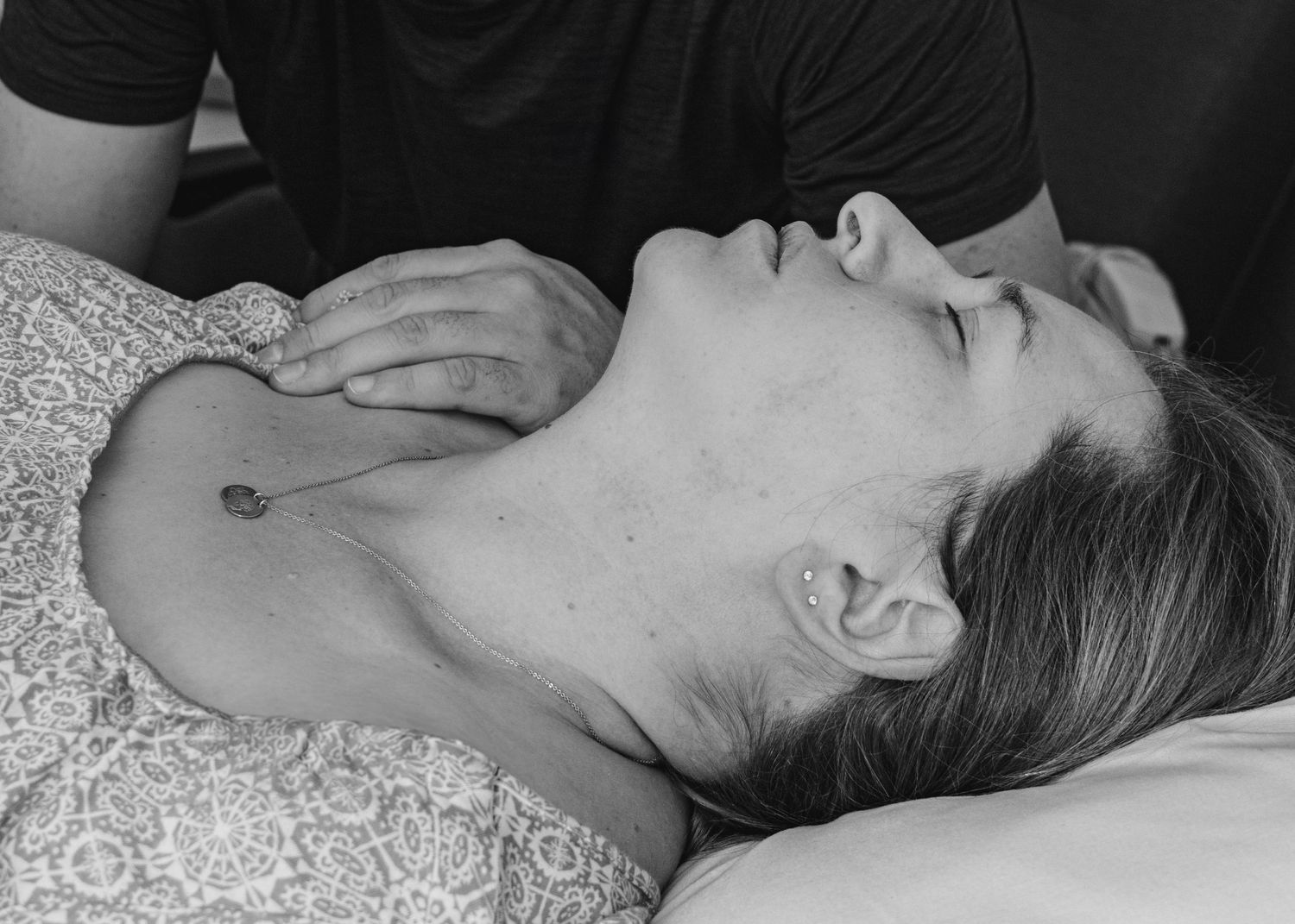Person receiving medical treatment while laying on examination table.