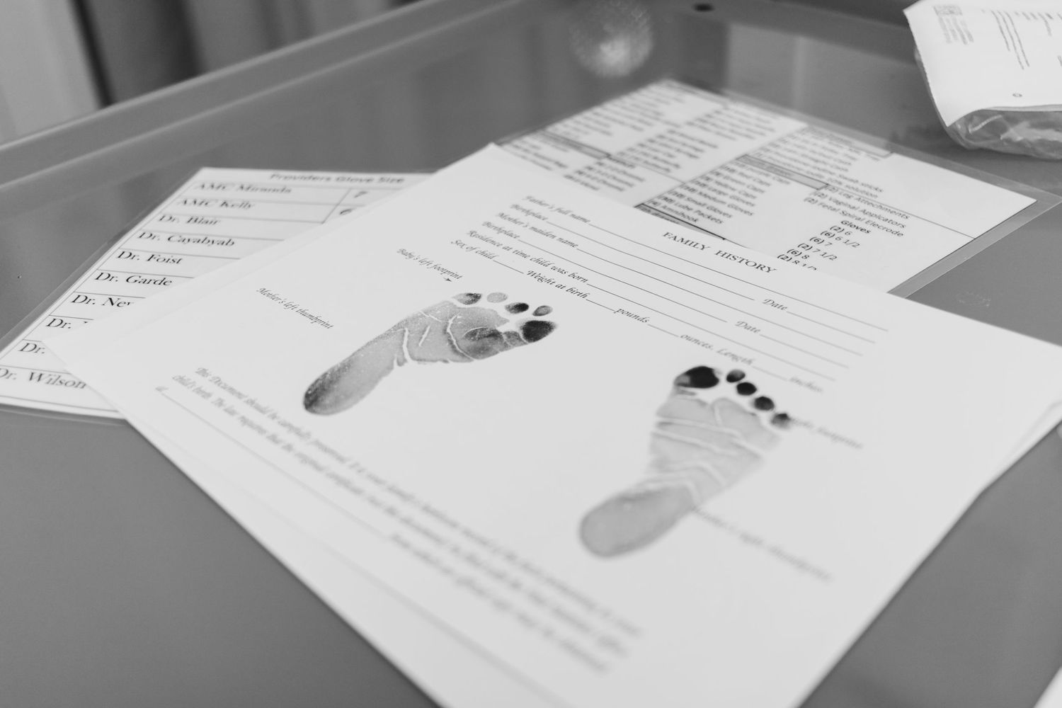 Black and white document showing baby footprints with medical information.