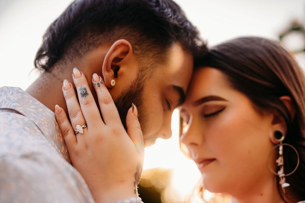 Couple stands with foreheads together for an engagement session in Bentonville, Arkansas.