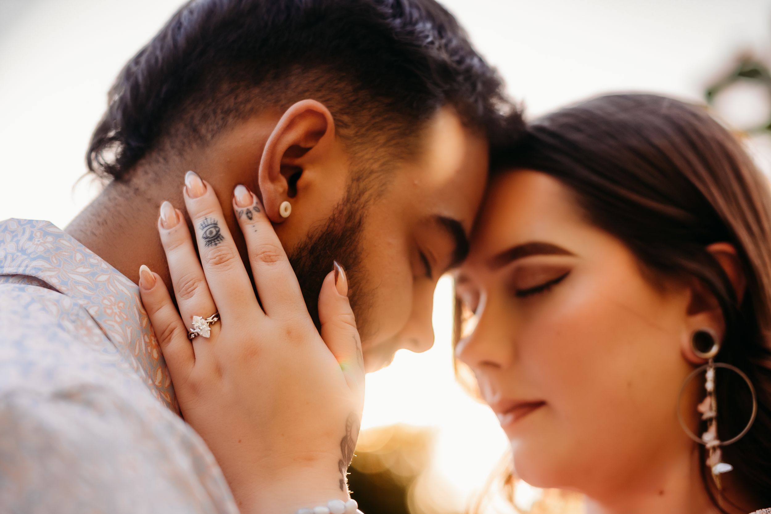 Couple stands with foreheads together for an engagement session in Bentonville, Arkansas.
