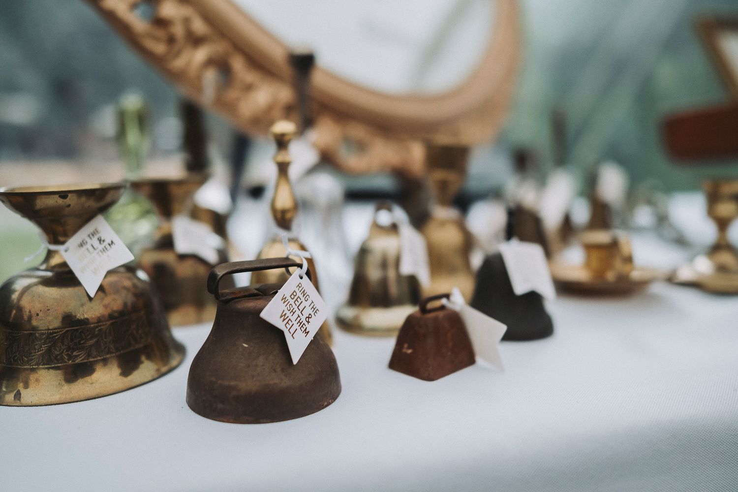 Wedding bells sitting on a wedding reception table, to be used as an alternative to a sparkler exit.