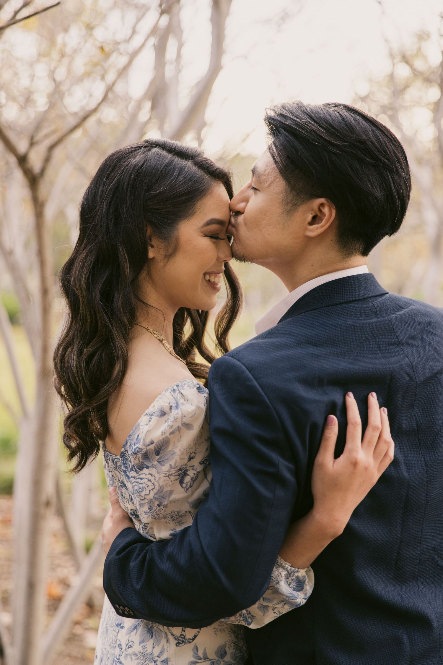 A romantic close-up of a couple sharing an intimate moment in a natural autumn setting.