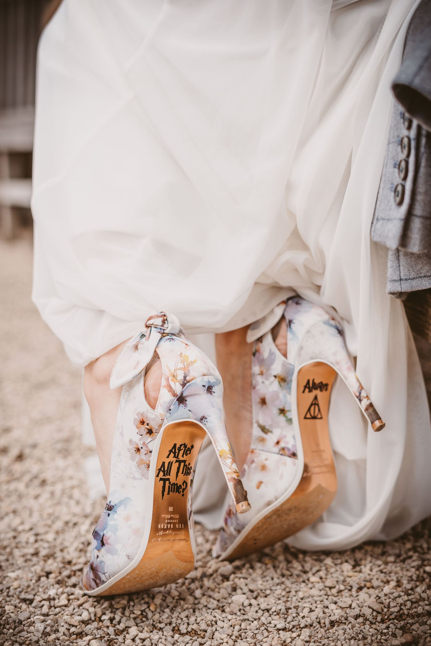 Close-up of floral wedding shoes with custom writing on soles.