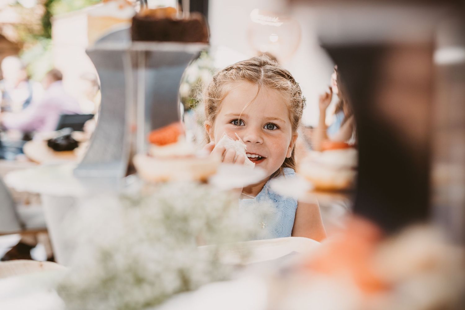 A candid moment captured at a wedding reception through decorative table settings.