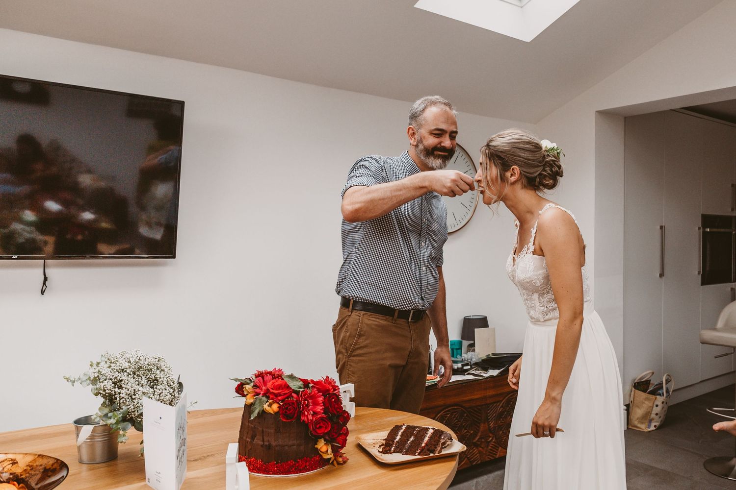 A joyful pair enjoying dessert together at a wedding reception.