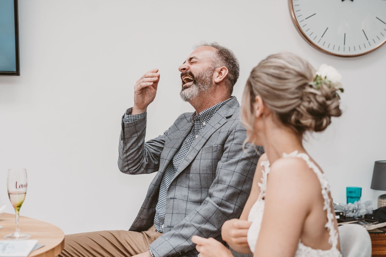 People share a heartfelt laughing moment during a celebratory event.