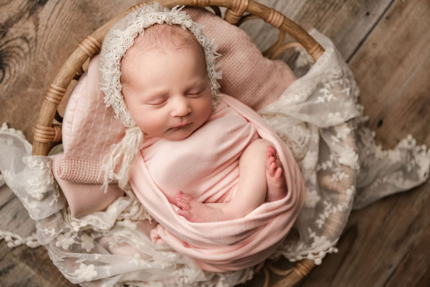 fine art portrait of newborn baby girl in prop with lace