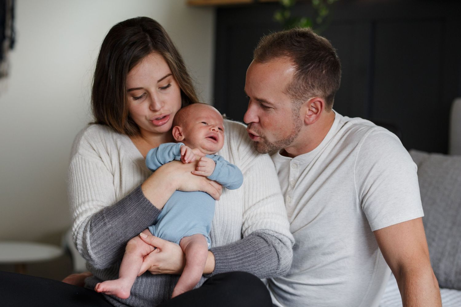 a mother and father hold their newborn son at an in home newborn session in Lake Stevens