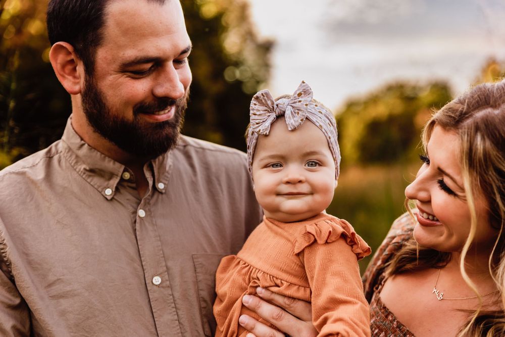 A joyful family moment captured outdoors during golden hour.