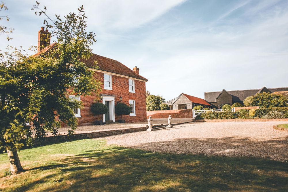 Beautiful rustic brick wedding venue surrounded by trees and rolling hills.