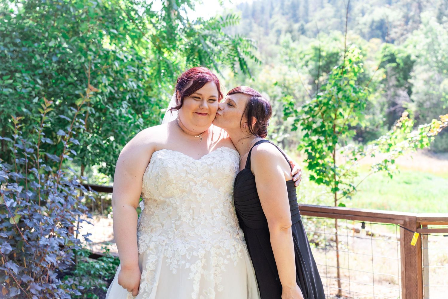 mother of the bride kisses bride