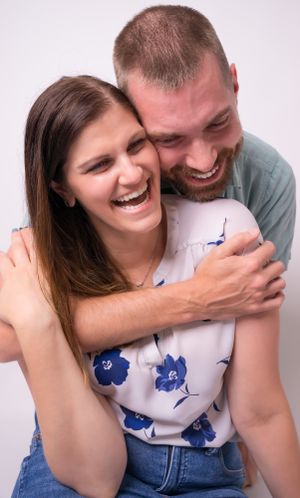 Candid shots of couple sharing genuine laughter during studio photoshoot.