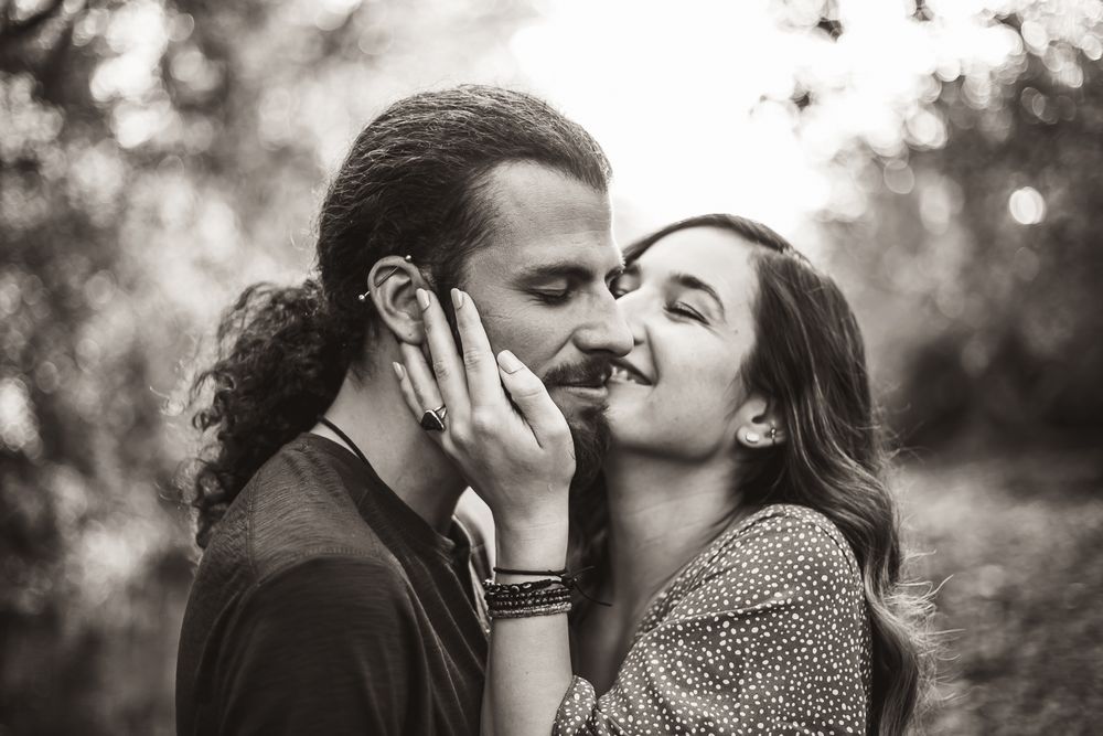Close-up black and white portraits of couple sharing intimate moments.