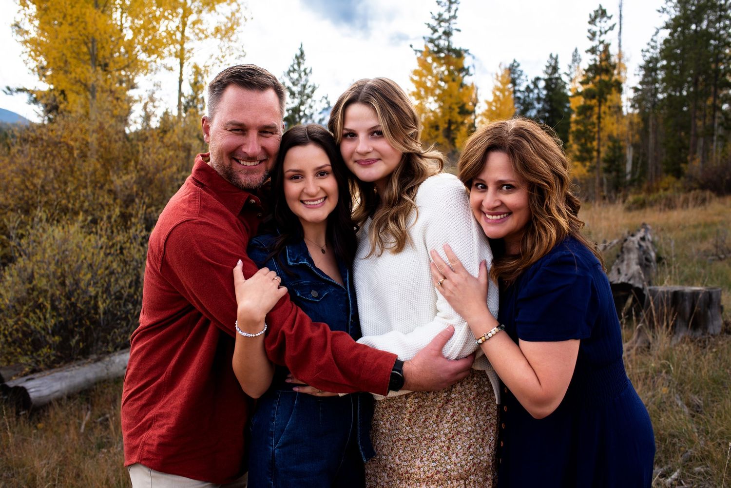Family with adult children standing in the mountains of Colorado
