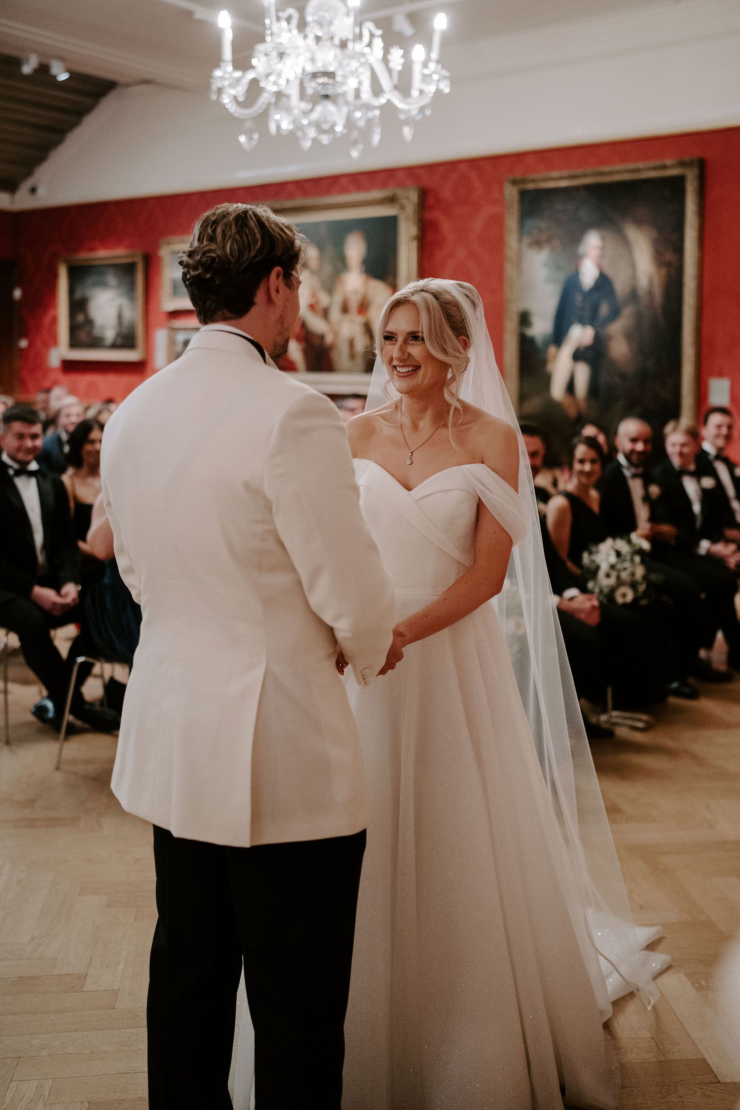 bride and groom holding hands at the alter in the European art gallery at the ashmolean museum