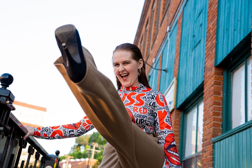 Ginger women throwing up her leg for a pose in Stillwater MN