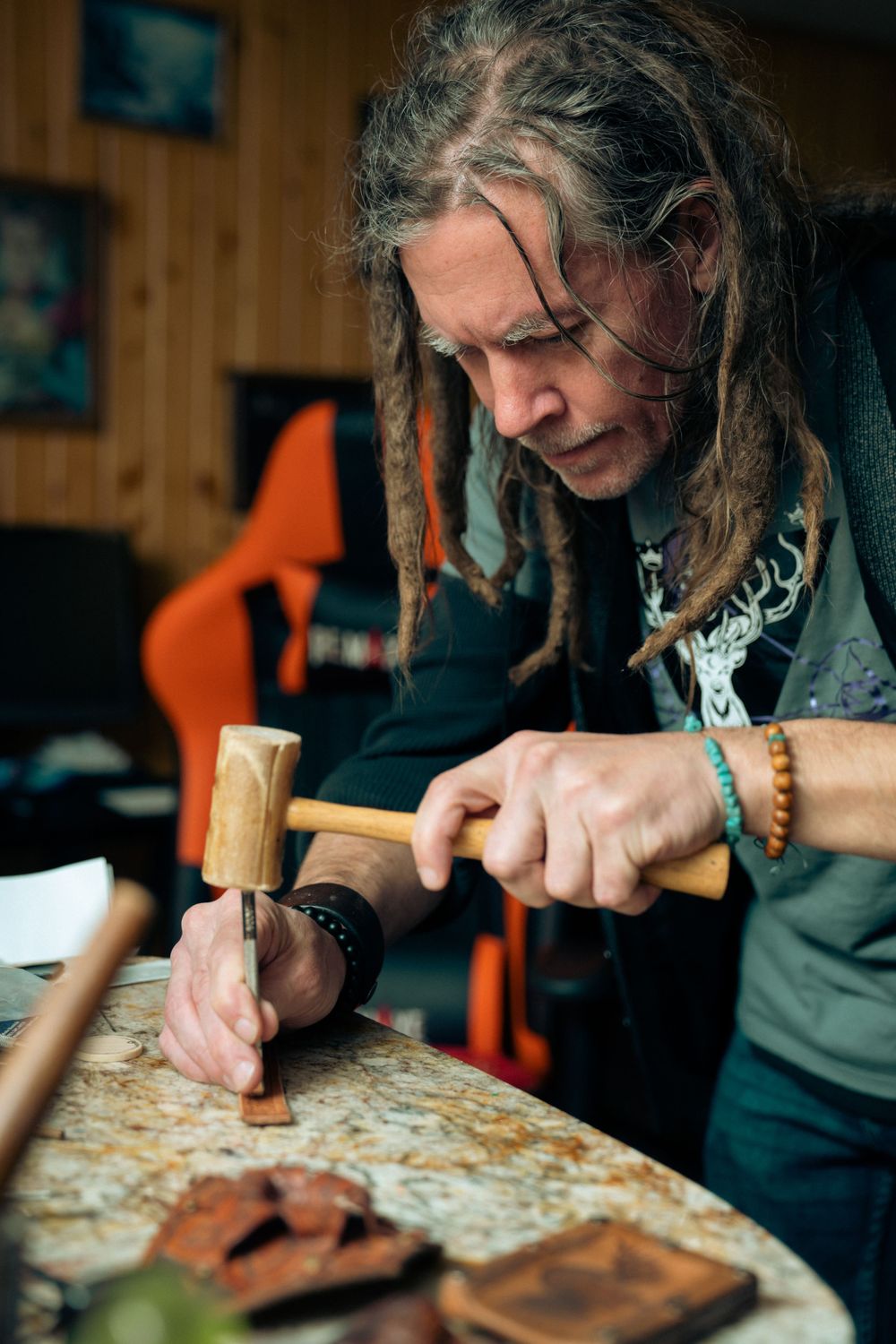 Artist making leather cuffs