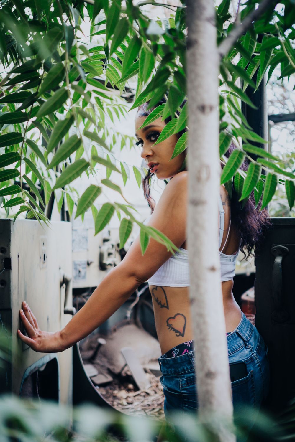 A tropical scene with palm fronds framing a figure in casual summer attire.