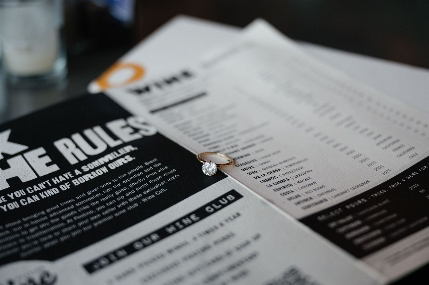 Restaurant menu pages laid out on dark surface showing food and drink options.