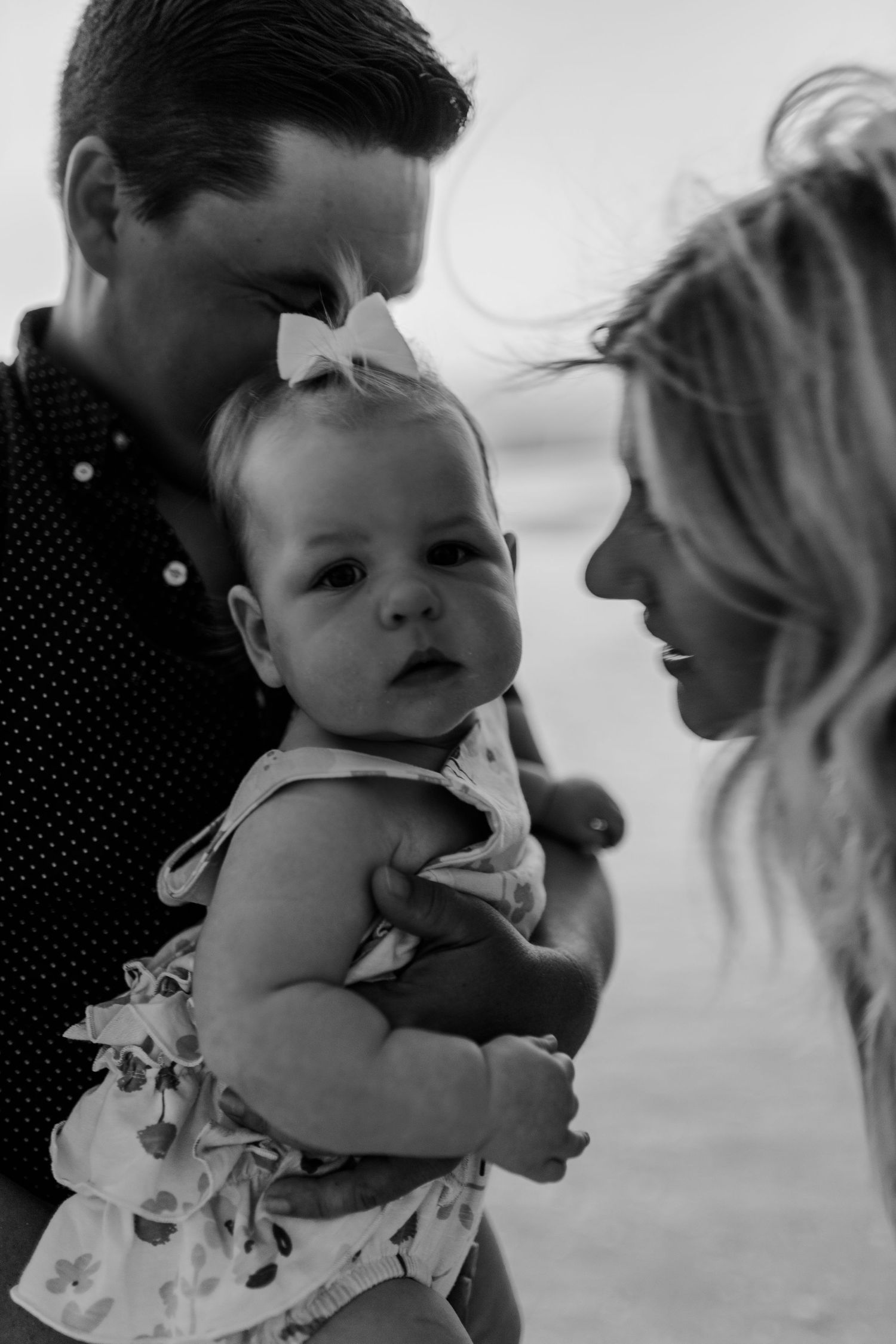 Intimate black and white family portrait showing tender expressions.