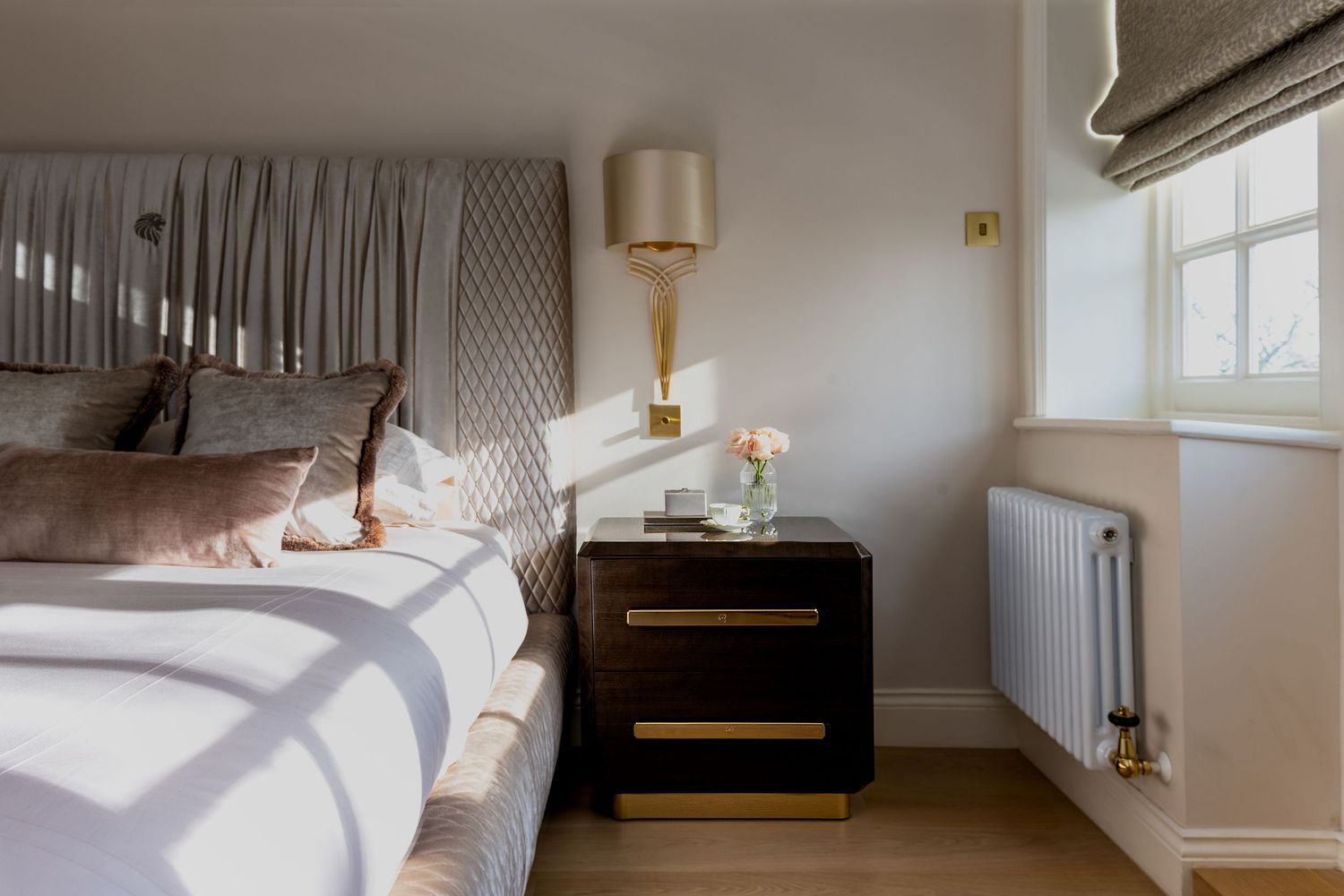 A bedside table with a rose vase
