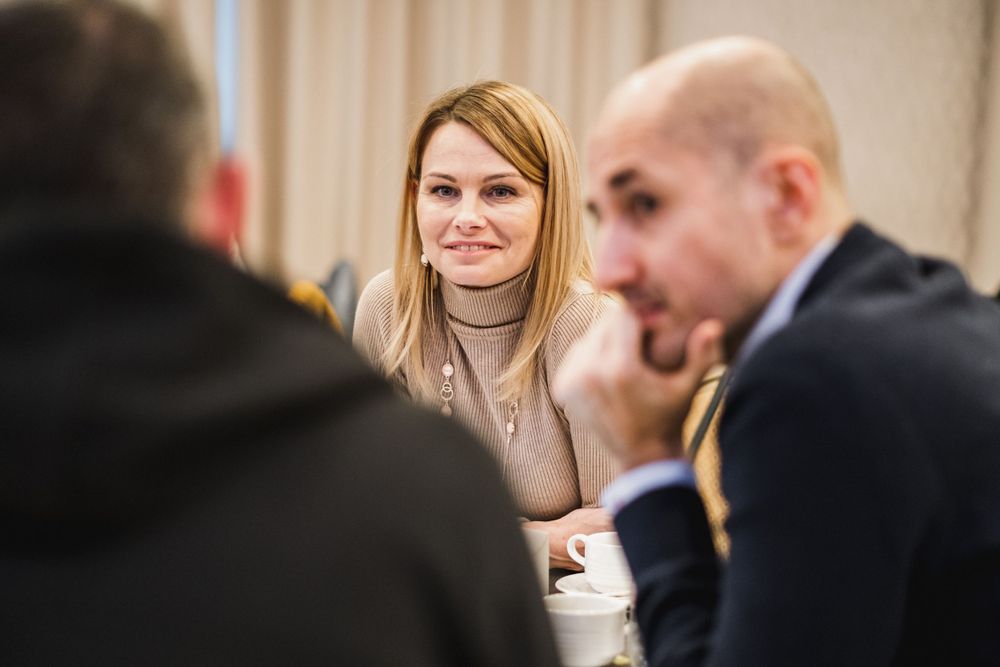Attendees participating in focused discussion during business meeting.