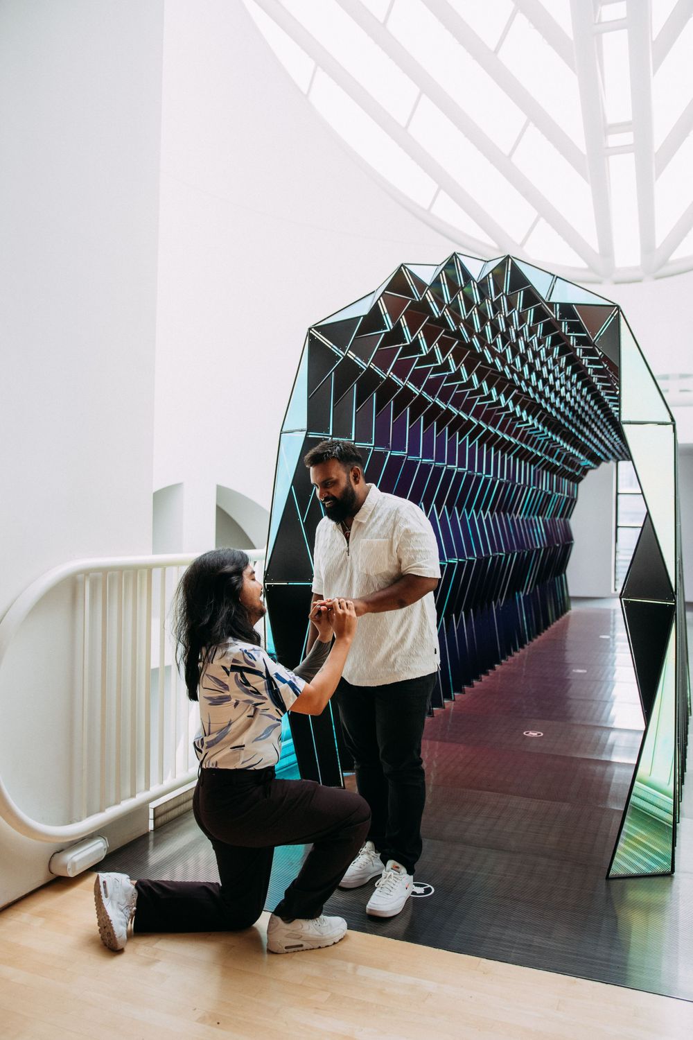Same sex proposal in front of one way color tunnel at SFMoMA.