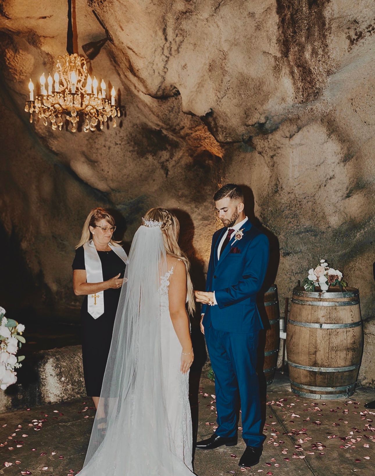 Wedding ceremony in Ironstone Vineyards wine cave, adorned with beautiful decorations and surrounded by barrels of aging