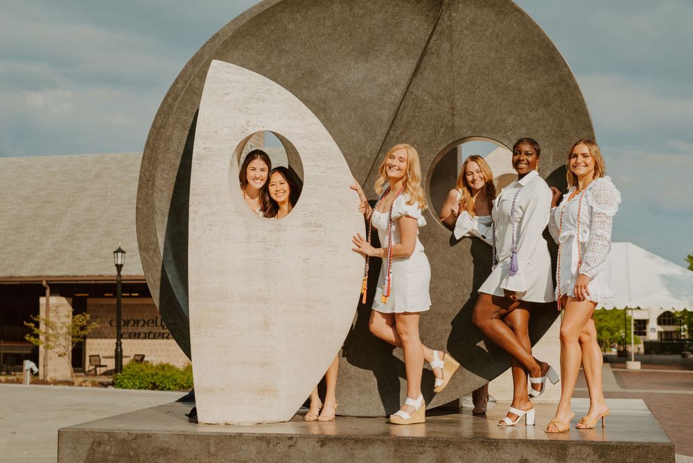 Villanova University graduates pose with Oreo Statue