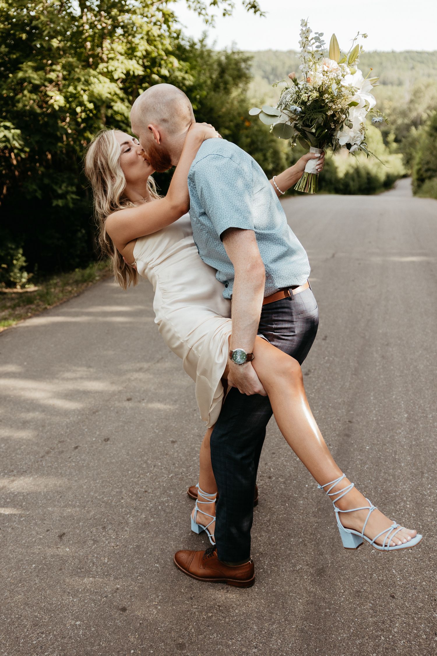 Romantic dance poses on a country road showing footwear details.