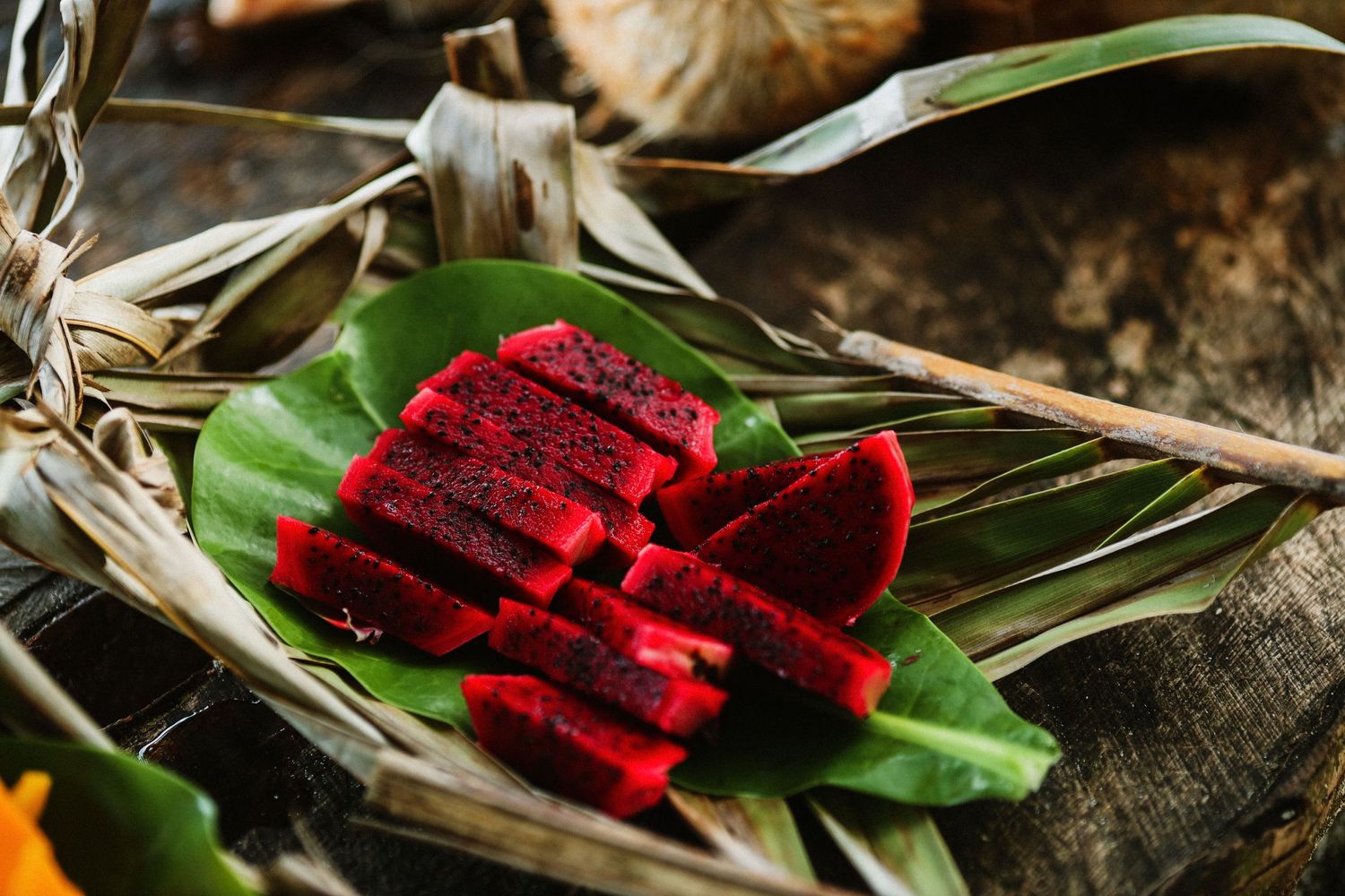 Vibrant red watermelon slices displayed on green banana leaves.