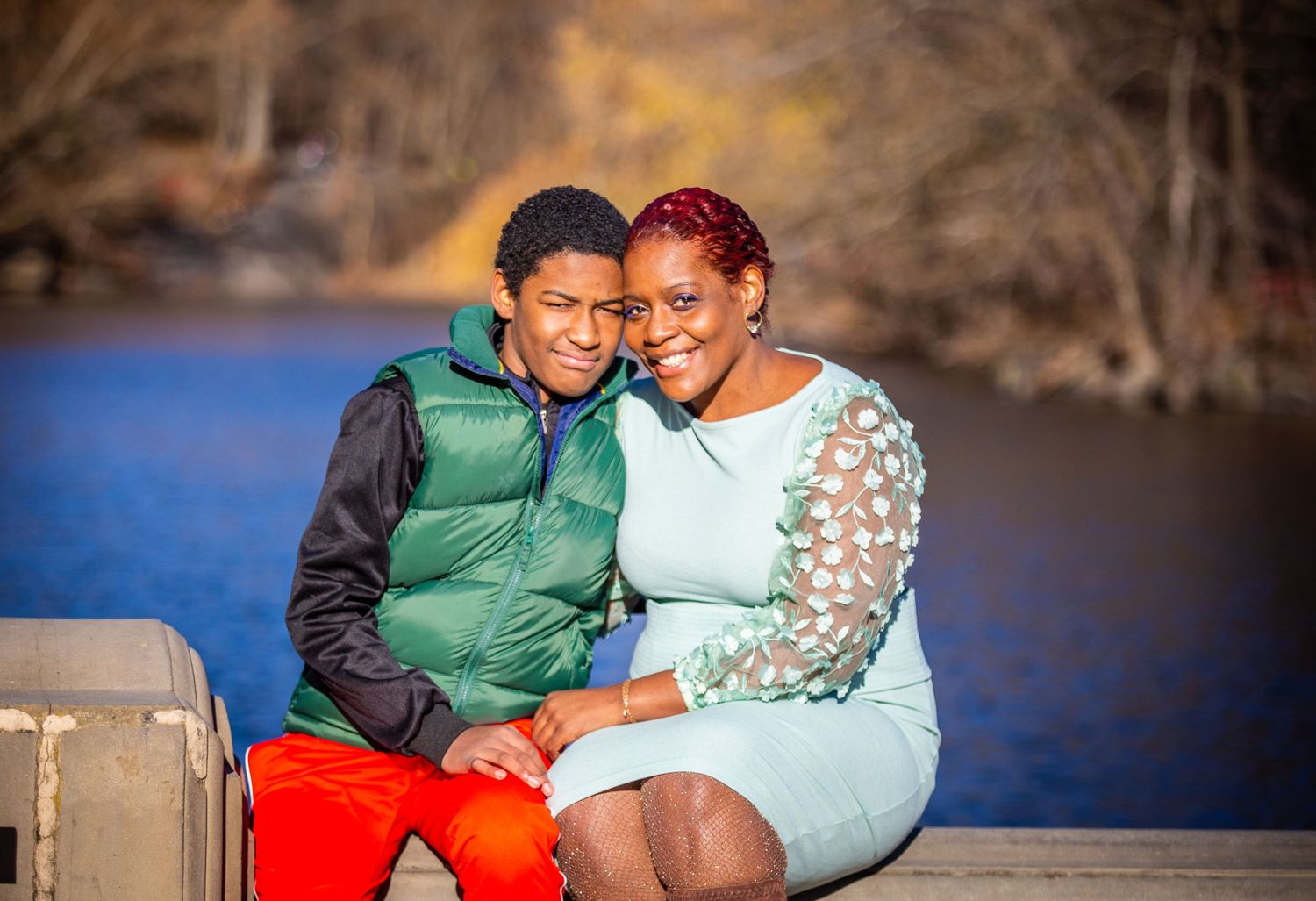mother and son sitting on ledge