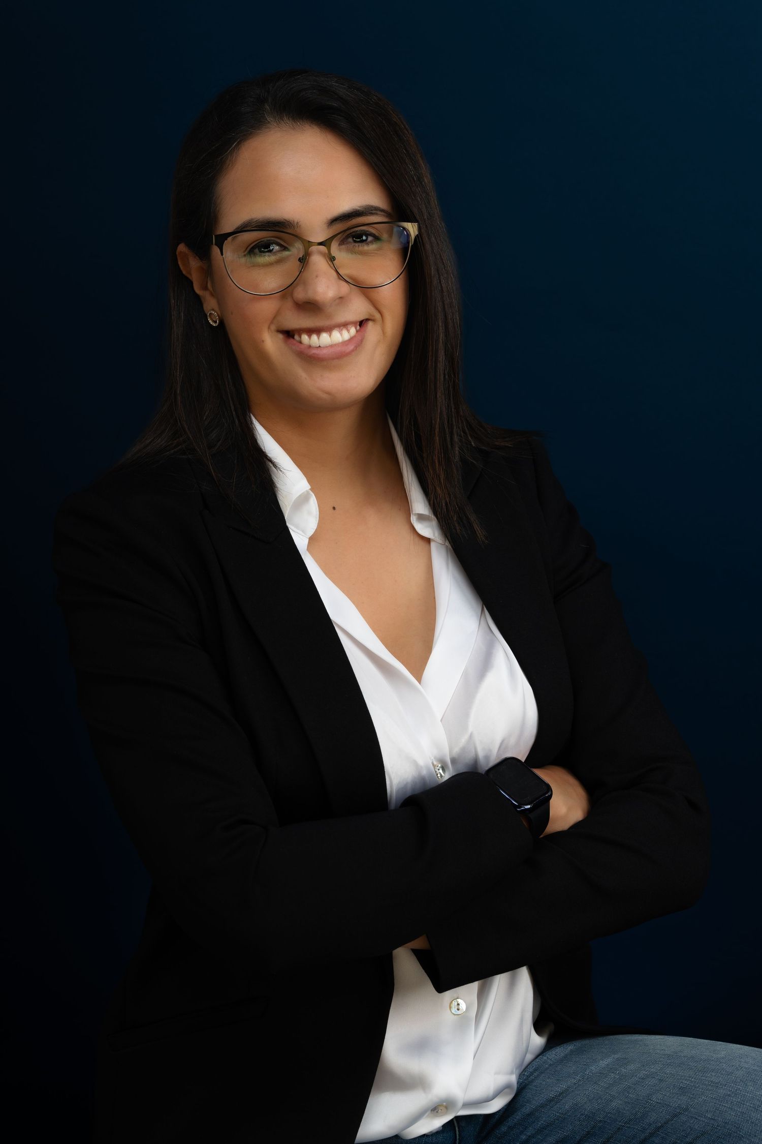 Professional headshots against dark blue background showing business attire and glasses.