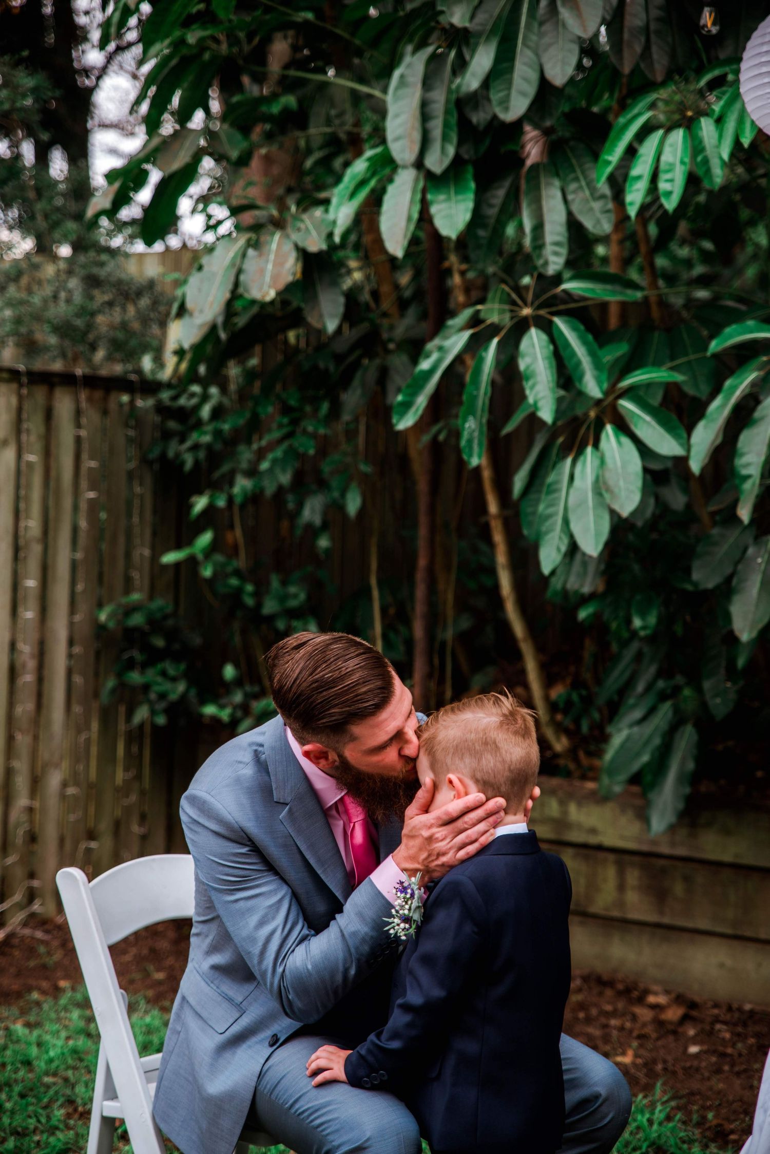 An emotional moment shared between two people during an outdoor wedding ceremony.
