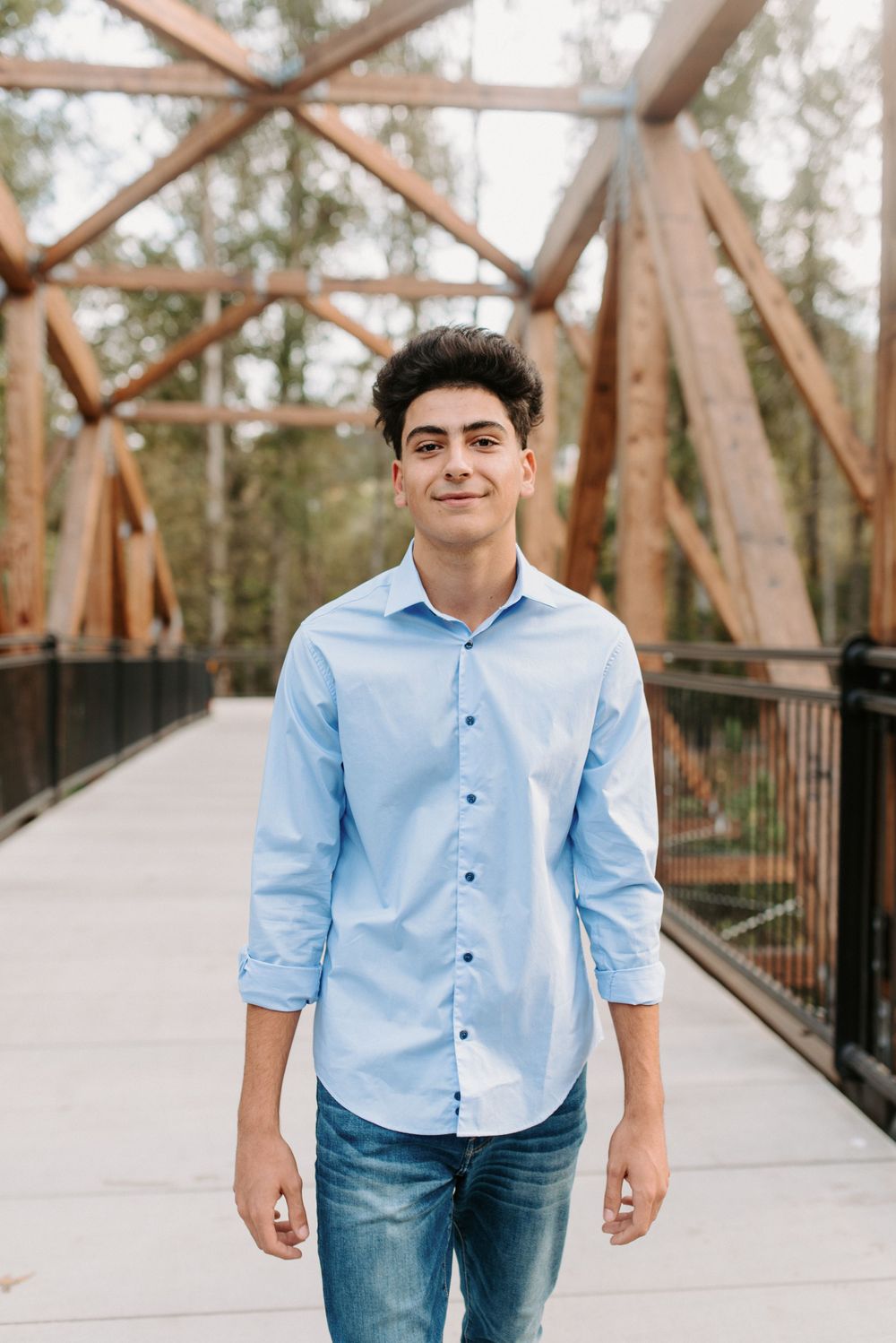 Portrait series on a wooden bridge walkway with industrial architectural elements.