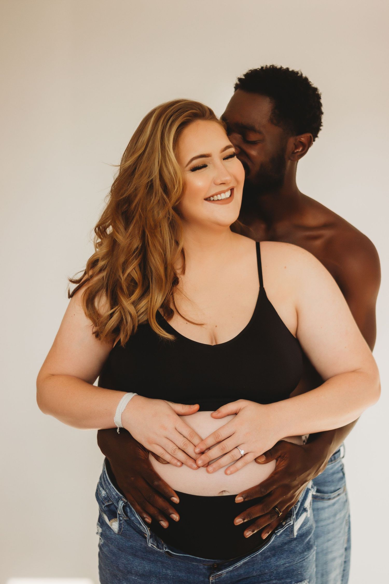 man holding pregnant woman's stomach